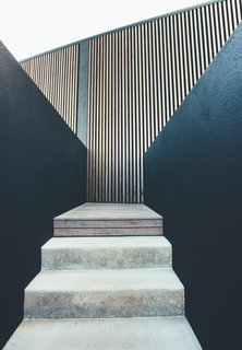 A stairway connects the home to a lower-level swimming pool. 