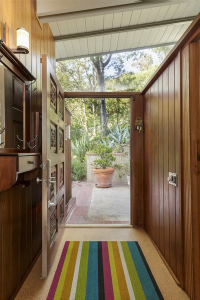 The elegant architecture of the home's classic midcentury profile features a low-slung roofline and an open floor plan. 

