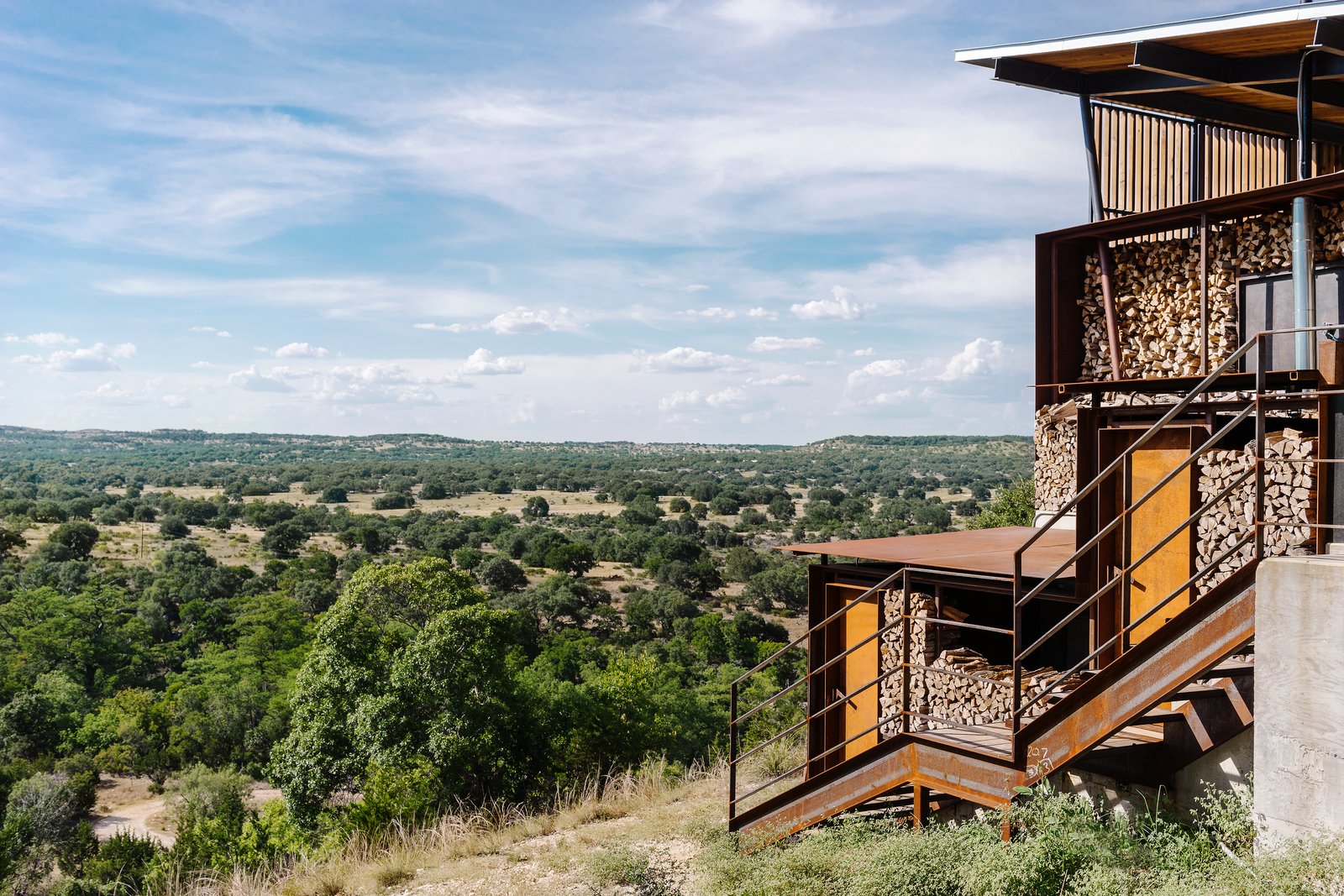 Exterior, Wood Siding Material, House Building Type, Metal Roof Material, Gable RoofLine, and Metal Siding Material The double-stacked wood wall from the exterior. Photo 11 of 13 in An Old Texas Ranch Becomes a Spectacular Family Haven
