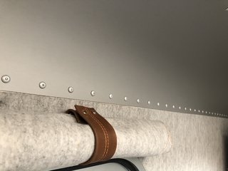 The gray wool-felt walls are dirt-repellent and feature roll-up window shades. 