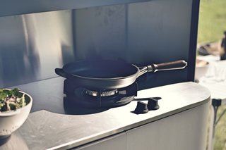 A stainless steel counter with two gas burners make outdoor cooking a breeze. 