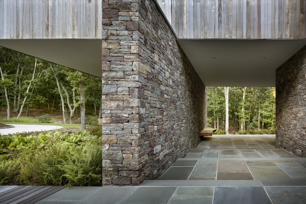 The home cantilevers out over the series of stone-retaining walls.