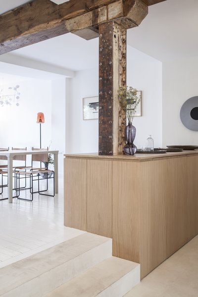 The kitchen is located a few steps down from the dining room. 

