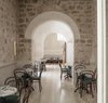 Modern home with Chair, Table, and Wall Lighting. One of the hotel's eating establishments is the New York-style deli Golda’s Delicatessen, whose decor includes modernist chairs from Thonet set against a backdrop of historic stonework. Photo 14 of Jaffa Hotel