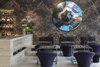 Modern home with Living Room, Bar, Coffee Tables, and Chair. The lobby also features a Sheshbesh (backgammon) lounge and has been completed with bespoke tables designed by Pawson, which pay homage to the traditional games that merchants play in the nearby Jaffa market. Photo 6 of Jaffa Hotel