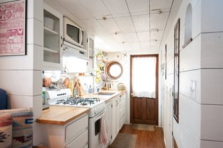 Kell found appliances which perfectly fit her small space: an 18" dishwasher, a 20" stove/oven, and a refrigerator that’s about a foot smaller than a full-sized one.