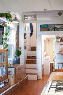 Kell didn’t want to have to climb ladders to access the bedrooms, so she built narrow stairways with doors to provide privacy. Transom windows above the doors open for air circulation when the thru-wall fans are on.
