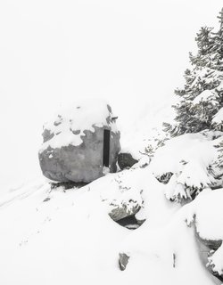 Inside the rock-shaped shelter is a wood-paneled square room. 
