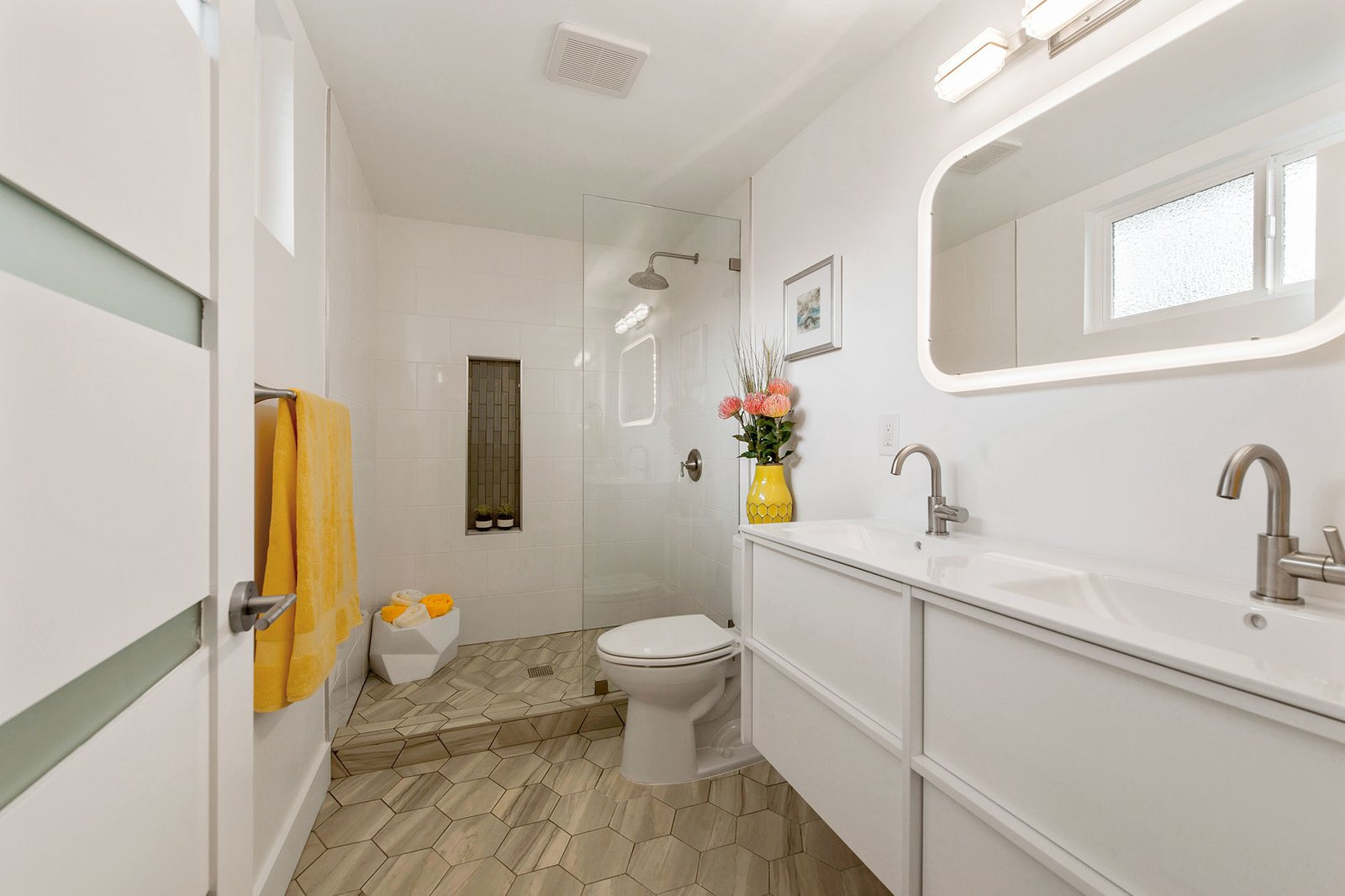 The master bath has a tiled shower and a double vanity. 