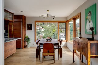 The open plan flows into the dining room, which also offers views of the hills. 