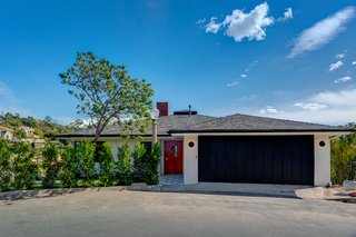 Behind this unassuming midcentury facade lies a beautifully updated home with spectacular views. 