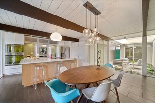 The kitchen opens to the dining area, rear garden, and atrium.