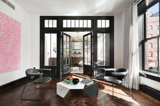 Full-height French doors lead to the second bedroom which is currently in use as a media room. The elegant built-in bookcase is from Amuneal’s Collector's Shelving system and was custom made in Philadelphia.