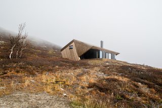 Located on the Imingfjell mountainside in Norway, this minimalist, 785-square-foot cabin features a "hood" in response to the climate and the region’s strict building regulations.