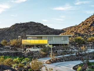 The encelia-green asbestos cement sheet facade is a distinctive part of the home’s design. 