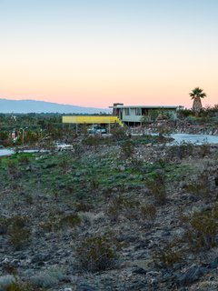 The Cree House feels larger than its modest footprint thanks to expansive walls of glass and the enormous front deck and rear patio, which link the home to the outdoors.