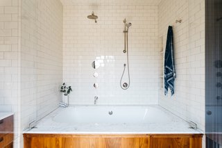 The subway tiles that cover the master bath are from Daltile.