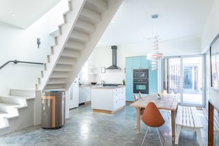 The floating staircase and open-plan interiors add to the home's contemporary feel.