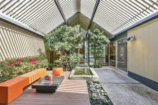 The sense of the outdoors is particularly strong in the central atrium; the space is awash in light and shadow.