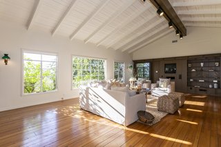 The bright and airy great room features a vaulted tongue-and-groove ceiling and a slightly more modern feel than the rest of the home. 