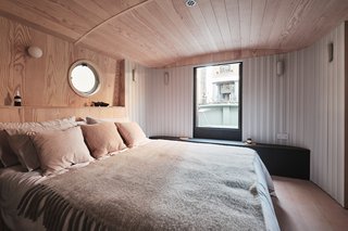 The houseboat has a single bedroom with a round porthole—lest you forget where you are staying. 