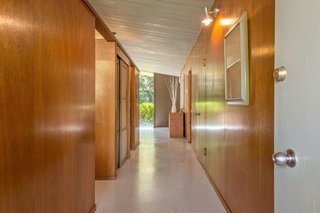 The entry hall is clad in original Philippine mahogany paneling for a warm, authentic midcentury vibe. 