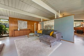 A dividing wall separates the living room from the kitchen. 