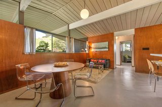 The dining area is bright thanks to an expanse of glass. 