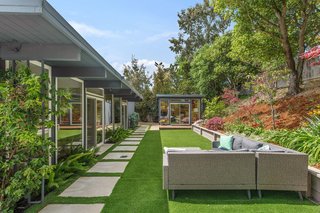 One of 574 Blackberry's highlights is the 120-square-foot backyard studio. The separate cabana perfectly matches the home's midcentury style.