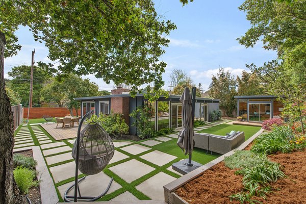 The beautifully landscaped backyard features a few separate sitting areas—perfect for entertaining and indoor/outdoor living. 