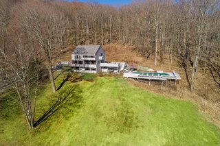 Outside, a large deck overlooks a saltwater pool and a hot tub.