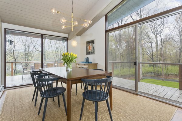 The dining room opens to the wraparound deck. 