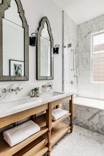 The guest bath features two sinks and lots of marble. 