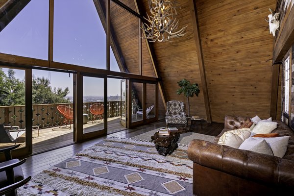 The living room features vaulted ceilings and a dramatic wall of glass which opens to a spacious balcony with gorgeous views.
