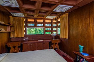 This bedroom features a built-in double desk.