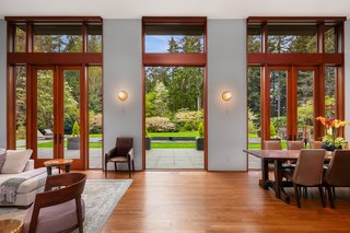 Full-height French doors topped with clerestory windows flood the open space with natural light. 