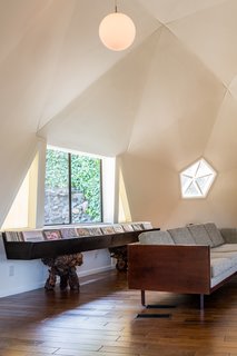 The geometric room is punctuated with windows and pentagon-shaped skylights.