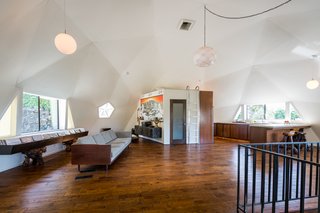 The lofty dome has a great room with a kitchen, dining, and living space. 