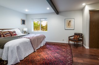 Exposed beams throughout the house echo the hardwood floors.
