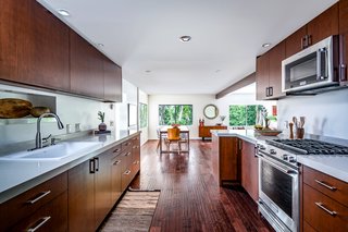 Warm wood cabinetry lines the kitchen. 