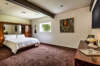 A winding staircase leads down to a bedroom, bathroom, and walk-in closet. 