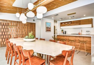 The stylish kitchen overlooks the dining area. Here the teak screen is closed.