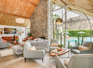 Full-height expanses of glass provide views of the backyard pool and the surrounding mountains.
