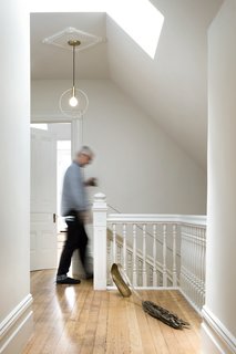 A skylight adds natural lighting at the top of the stairs. 