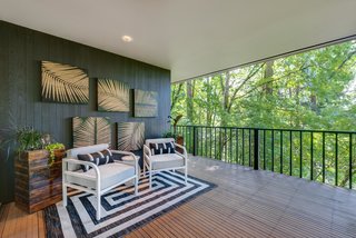 A small covered lanai-like patio provides a place to enjoy the outdoors, even if it's raining. 