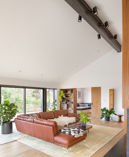 The living room ceiling was vaulted and one exterior wall was pushed out towards the backyard pool. A small bedroom was opened up to the living room and transformed into a children's playroom with a sliding door that can be closed off as needed. <br> <span style="color: rgb(204, 204, 204); font-size: 13px;">Photo by Josh Partee</span>