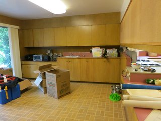 With "pepto-colored countertops and stained linoleum flooring" the original kitchen was dark and in desperate need of updates. 