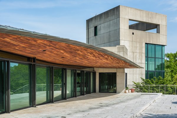 The International-style home features custom metal and woodwork, unique skylights, and glass canopies. The rectangular tower houses the master bedroom, a private penthouse study, and a rooftop observatory.