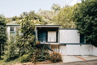 The home is quietly nestled into the surrounding greenery. 