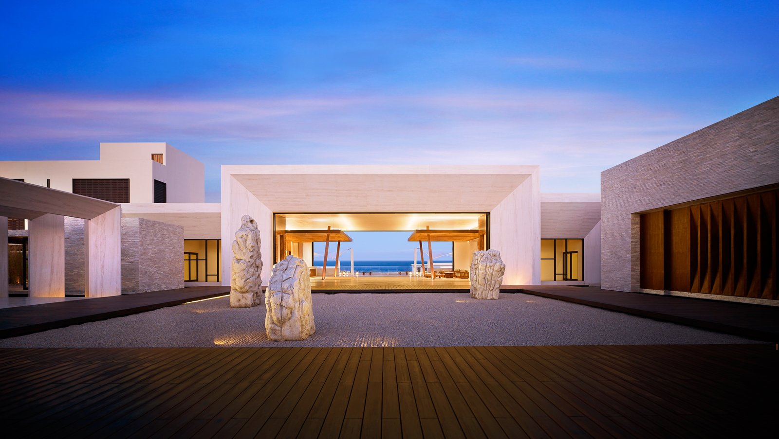 The dramatic entry features a stone-framed ocean view that creates a "portal to the Pacific" and a zen rock garden designed by WATG and David O. Design. 